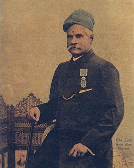Vintage self-portrait of the celebrated Indian artist Raja Ravi Varma, clad in traditional attire with a turban, a dark coat, and displaying medals of honor, exemplifying his prominence in Indian art history.