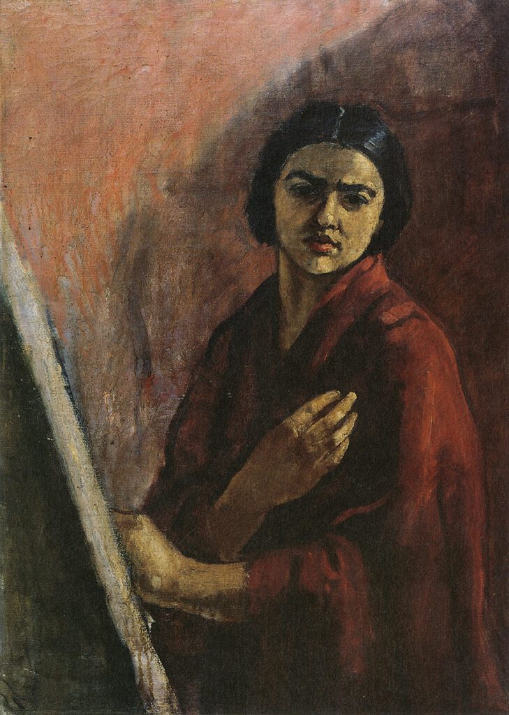 Amrita Sher-Gil's self-portrait showcasing her intense gaze and a contemplative expression, clad in a deep red garment, with a painting easel partially visible, exemplifying her bold artistry and profound personal narrative.