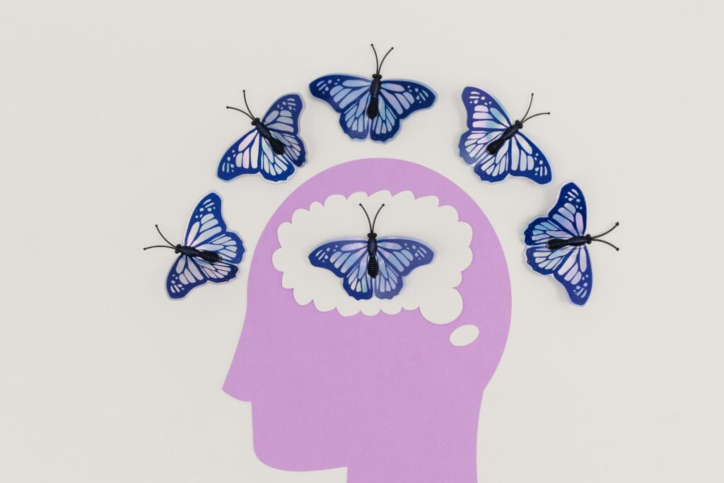 Silhouette of a human

head with paper butterflies emerging, symbolizing the liberation of creative thoughts often trapped during an art block.